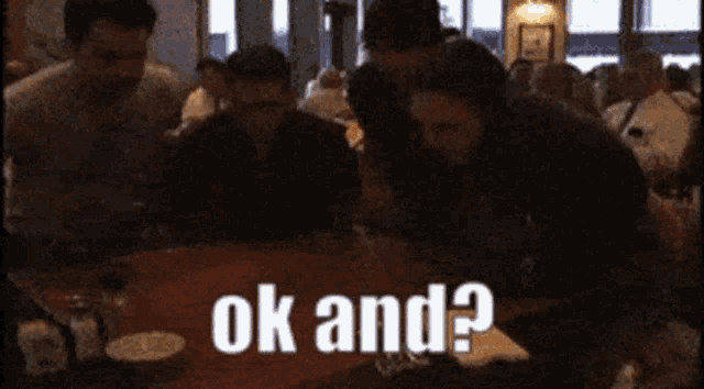 a group of people sitting at a table with the words ok and written on the table