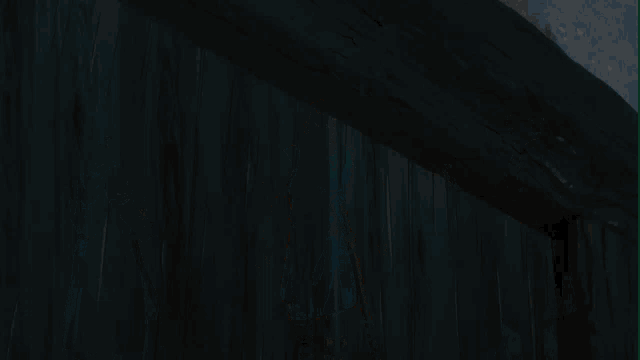 a close up of a wooden beam with a shadow on the wall
