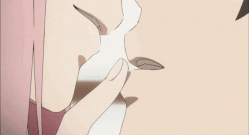 a close up of a person 's face with a pink haired girl kissing a man .