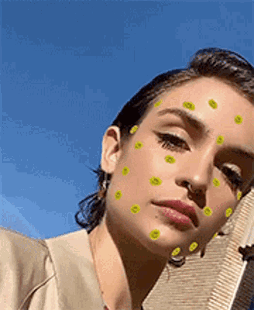 a close up of a woman 's face with smiley faces on it .