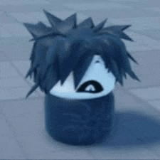 a person with a wig on their head is sitting on a block on the ground .