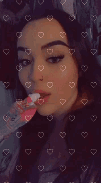a woman blowing a kiss with hearts around her