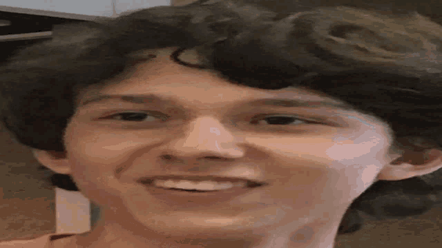 a close up of a young man 's face smiling .