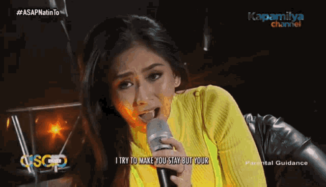 a woman singing into a microphone on a channel called kapamilya channel