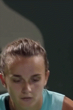 a close up of a woman 's face with a blue shirt