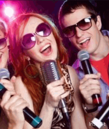 a group of people singing into microphones while wearing sunglasses