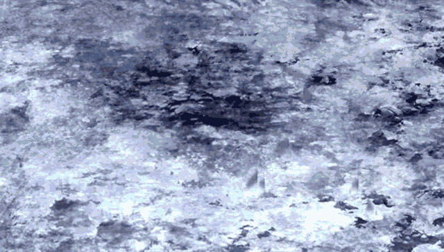 a close up of a gray marble texture with a few white spots