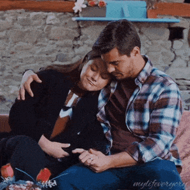 a man and a woman sitting on a couch with the words mylifeveryory on the bottom right