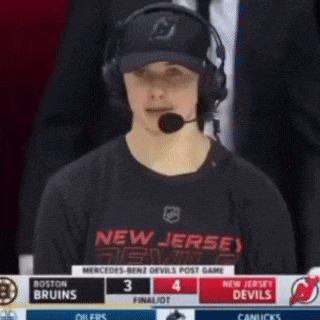 a man wearing headphones and a new jersey devils jersey