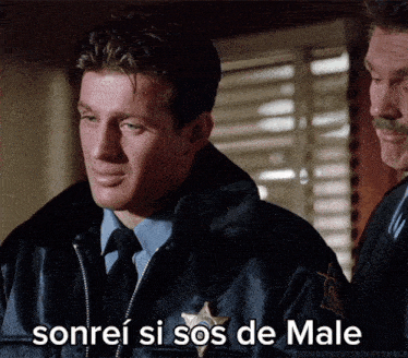 a man in a sheriff 's uniform is smiling with the words sonrei si sos de male below him