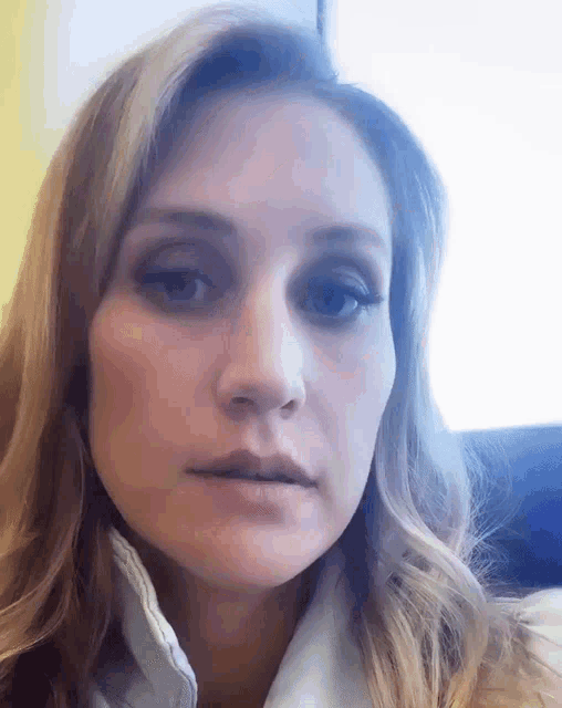 a close up of a woman 's face with her mouth open