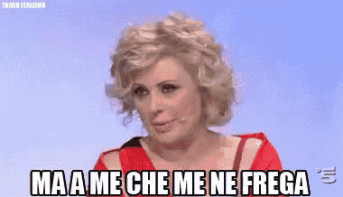 a woman in a red dress is saying ma a me che me ne frega .