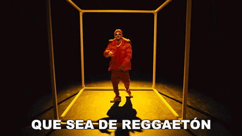 a man in a red jacket is dancing in a dark room with the words que sea de reggaeton written on the bottom