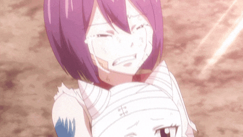 a girl with purple hair is crying while holding another girl in her arms