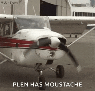 a small propeller plane is sitting on the ground with the words `` plen has moustache '' written on it .