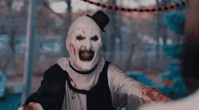 a clown with a top hat and a white mask