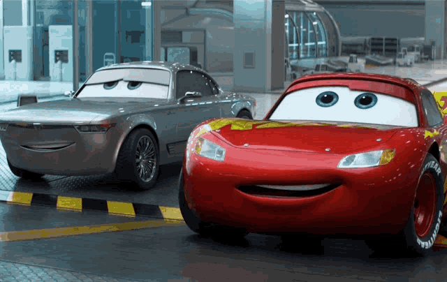 two cars from the movie cars are standing next to each other and smiling
