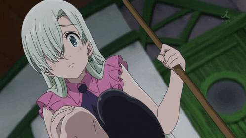 a girl in a pink shirt is holding a stick in her hand