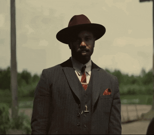 a man in a suit and hat with the words nah we good written below him