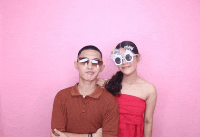 a man and a woman standing next to each other wearing sunglasses that say happy birthday