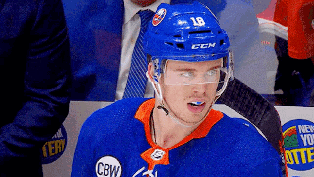 a hockey player wearing a helmet that says 18 on it
