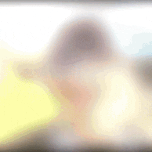 a blurry picture of a person 's face with a white background