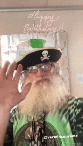 a man with a beard wears a pirate hat and glasses and says happy birthday
