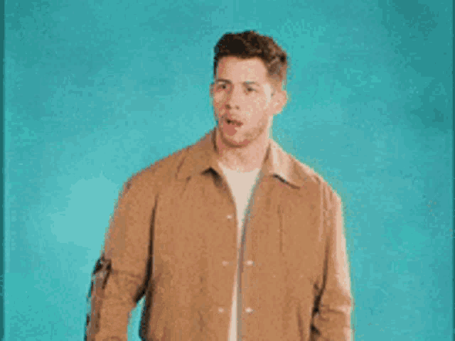 a man in a brown jacket is making a funny face