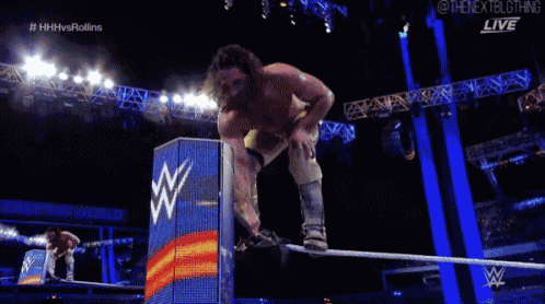 a wrestler is falling through the air during a match