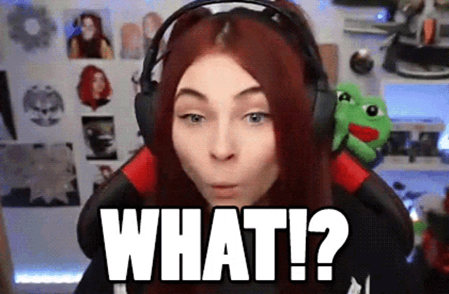 a woman wearing headphones says what ? in front of a stuffed animal .