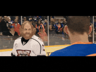 a man with a beard wears a jersey that says wolves on it