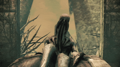 a statue of a monster with a long tentacle is sitting in the woods