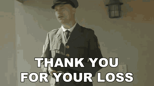 a man in a military uniform is standing in front of a sign that says thank you for your loss