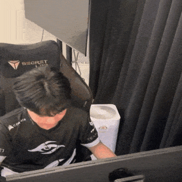 a man is sitting in a chair that says secret on it