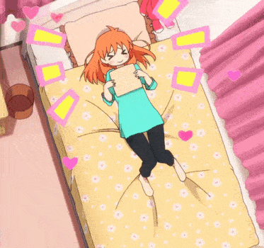 a girl is laying on a bed with hearts and flowers on it