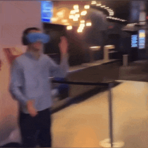 a blurry picture of a man wearing a blue virtual reality headset