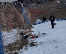 a person walking down a snowy hill wearing a sweatshirt that says ' washington redskins '