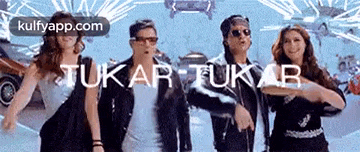 a group of people are standing next to each other in front of a sign that says tukar tukar .