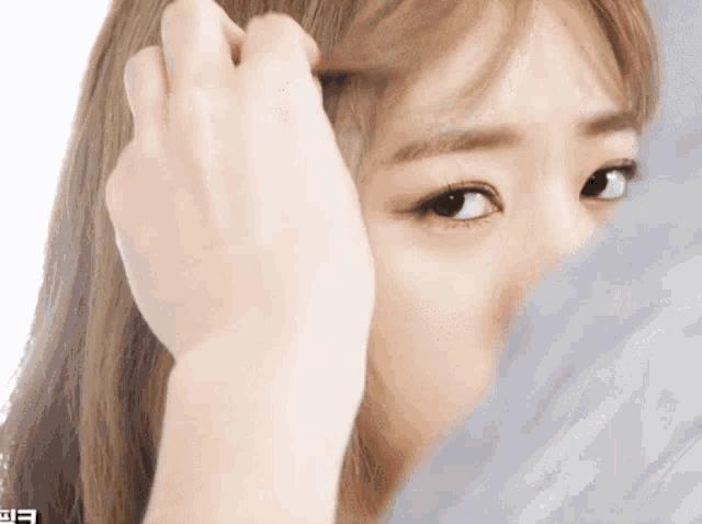 a close up of a woman 's face with the letter e visible in the corner