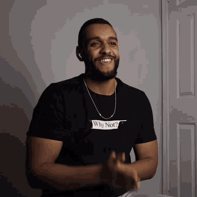 a man wearing a t-shirt that says why not