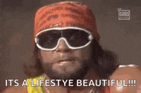 a wrestler wearing sunglasses and a bandana is saying `` it 's a lifestyle beautiful ! ''