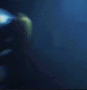 a person is standing in a dark room with a red light surrounding them