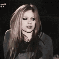 a woman with long hair is making a funny face while looking at the camera .