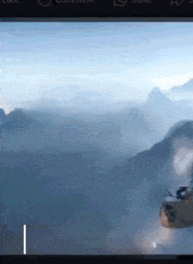 a screen shows a plane flying over a mountain range