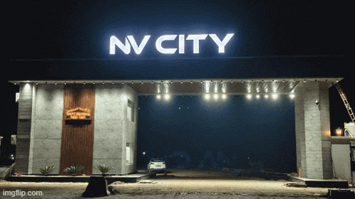 a sign that says nv city is lit up at night