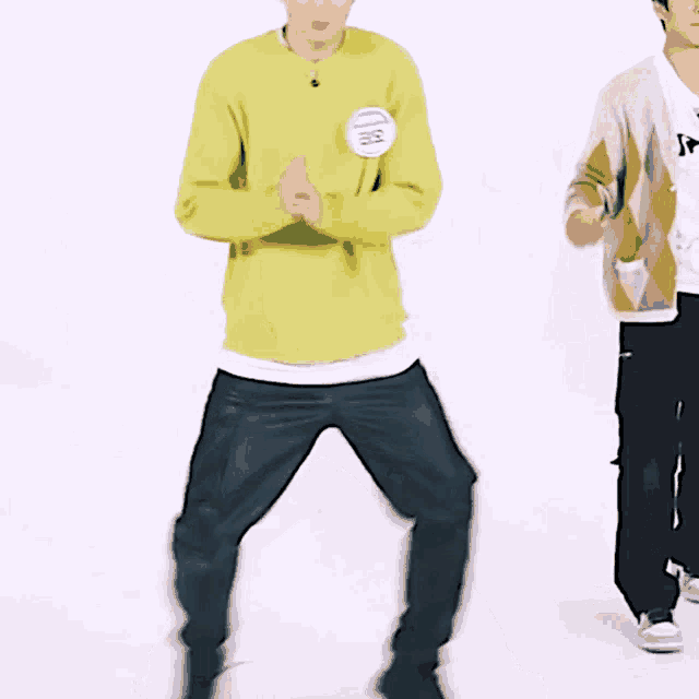 a man in a yellow sweater has a name tag that says ' ec ' on it