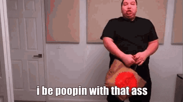 a man in a black shirt is holding a bag of potato chips and says `` i be poopin with that ass '' .