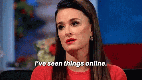 a woman in a red shirt is sitting at a table and saying `` i 've seen things online '' .