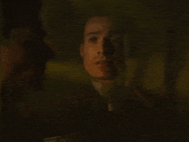 a close up of a man 's face with his eyes closed