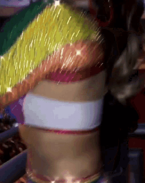 a woman 's torso is shown with a rainbow colored top on